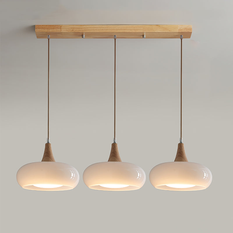 Eloria Pendelleuchte aus bernsteinfarbenem Glas, Holzaufsatz, Cluster mit 1–3 Leuchtenköpfen