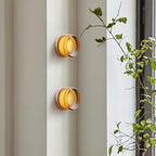 Lámpara de pared redonda de aluminio CircaGlow para un brillo ambiental cálido en espacios modernos