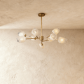 Luxora kopparkrona med frostat geometriskt glas och borstad guldfinish