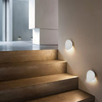 Lampada da parete LED NovaCurve nera opaca e bianca con bagliore ambientale
